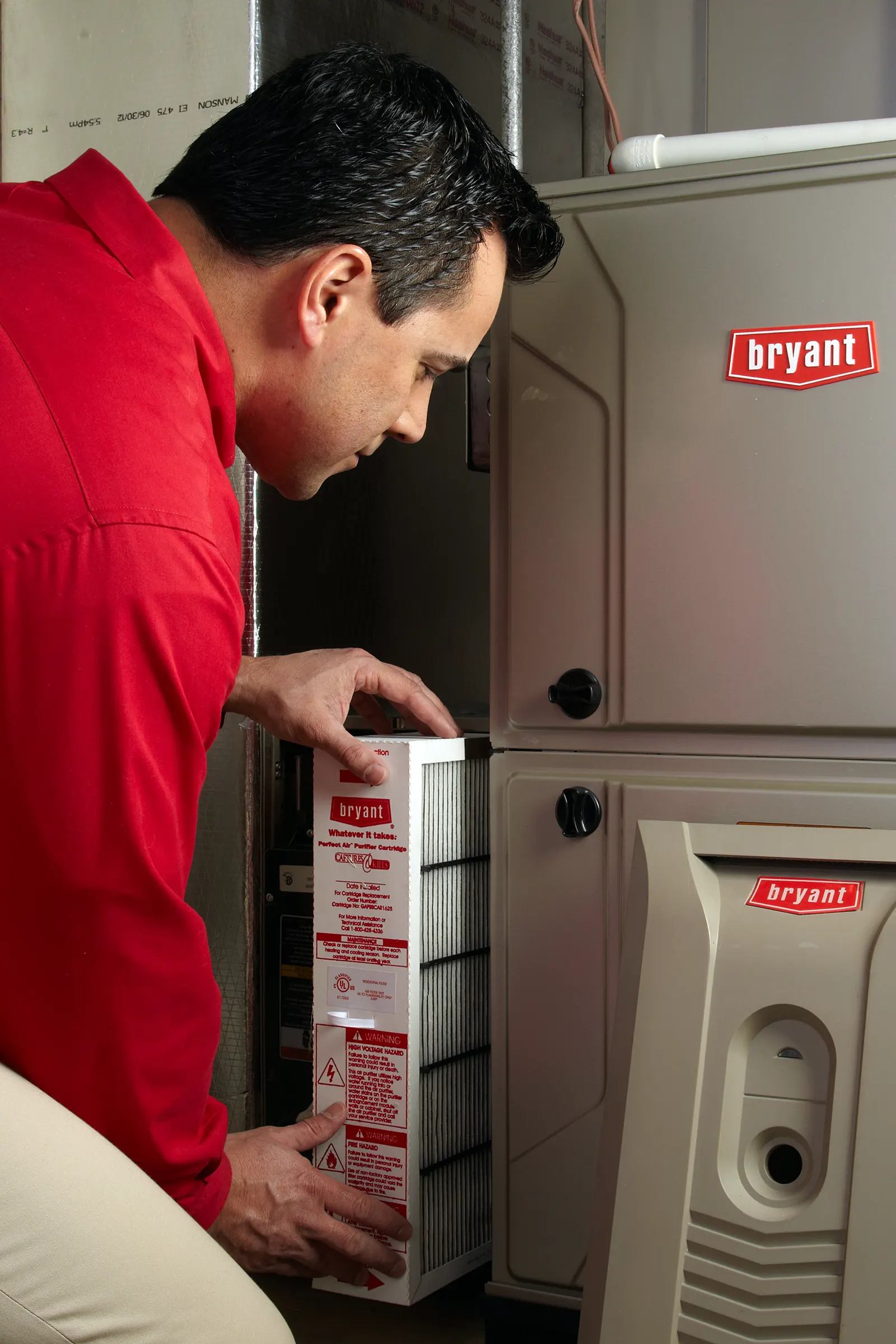 Service technician installing a new air filter| Furnace Repair | ZAP Cooling and Heating