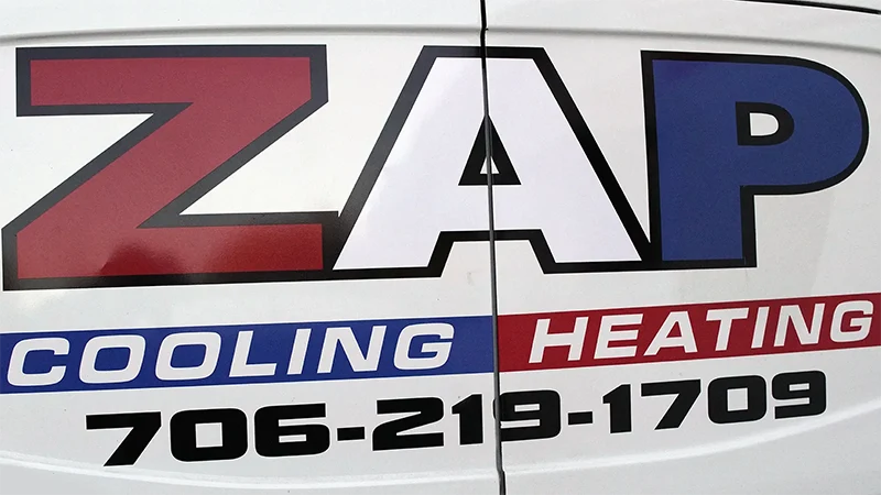 Rear View of ZAP Cooling & Heating's logo on the back of service van | Heat Pump Repair | ZAP Cooling and Heating